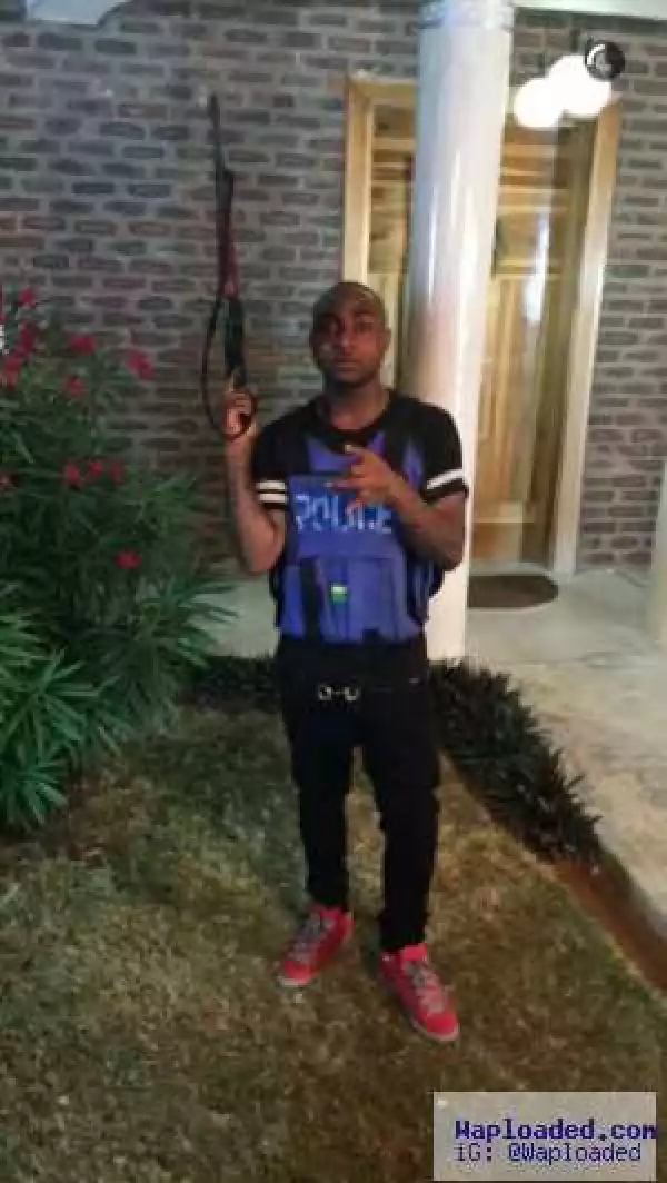 Davido Shows Off His Ak47 As He Turns Police Officer In New Video; Examines A Lady’s Behind